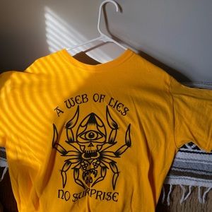 Web of yellow lies shirt.